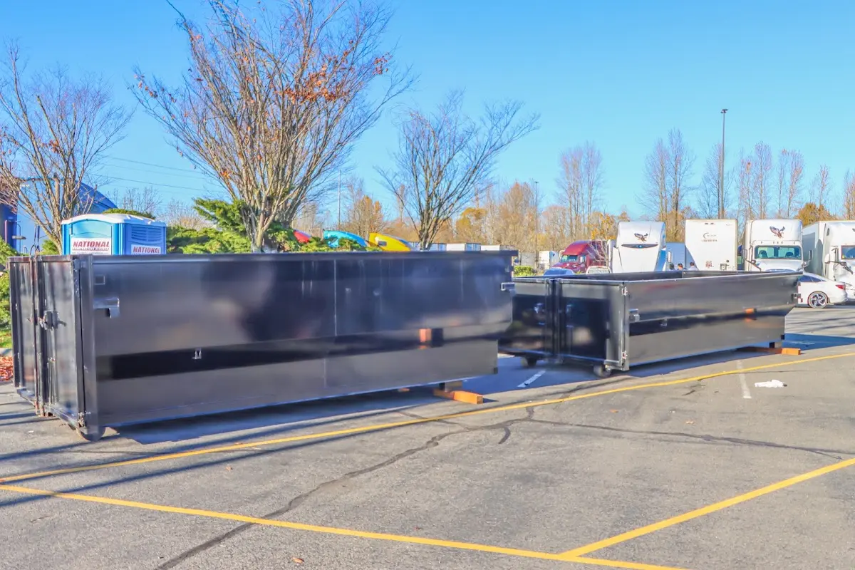 Professional dumpster rental service with roll-off container on residential driveway in Pleasanton